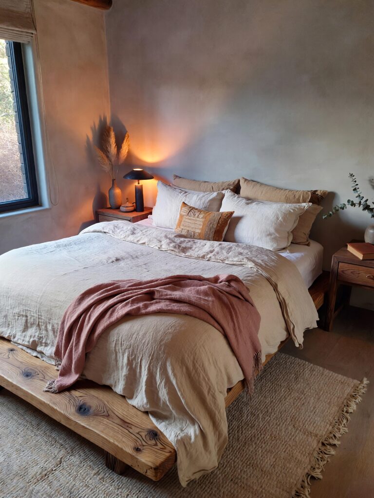 Cozy romantic bedroom with soft neutral bedding, warm lighting, and calm interior decor