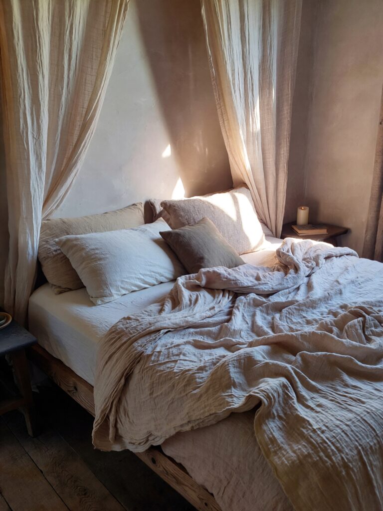 Minimal romantic bedroom with warm neutral tones and soft lighting