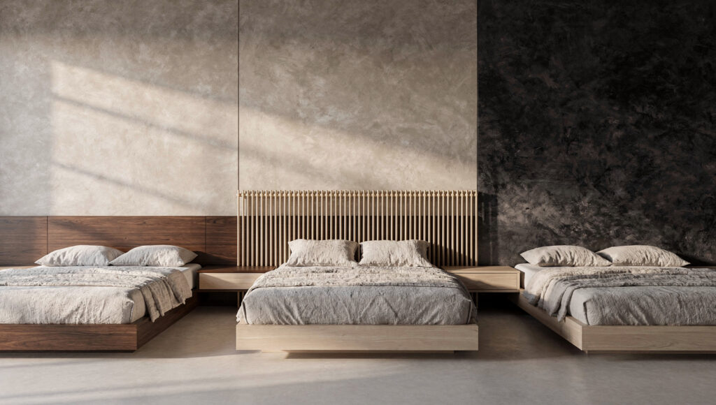 Three Japandi headboard styles side by side against warm greige limewash walls — an integrated seamless walnut headboard extending into built-in nightstands on the left, a spindle headboard with light oak dowels showing the textured wall through the gaps in the center, and no headboard at all exposing a deep charcoal limewash wall on the right