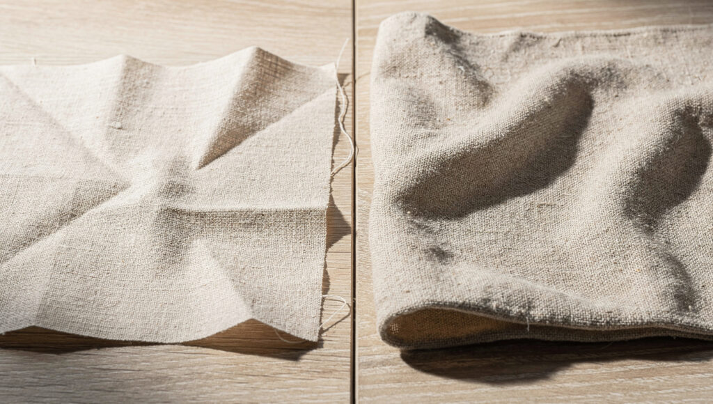 Two oat linen swatches compared, one lightweight with sharp creases and one heavyweight with soft rumple.